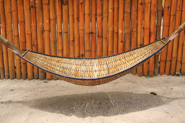 Bamboo wooden cradle or hammock hanging in the garden.