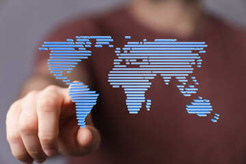 Hand interacts with digital world map.  Global business, technology, internet concept.
