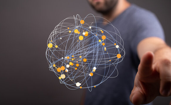 Abstract image of a man interacting with a digital sphere representing global network connections and data points.