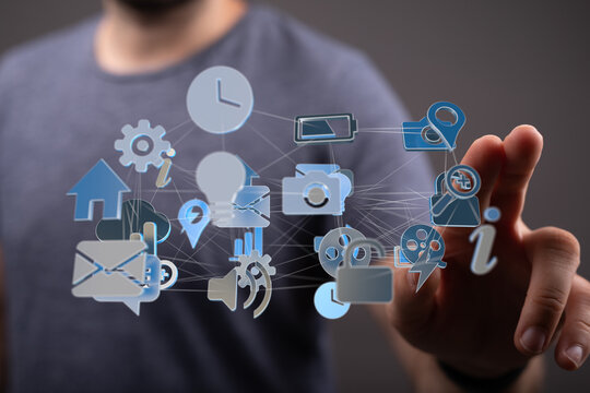 Person interacting with a digital network of icons, representing technology and connectivity.