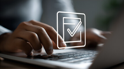 Digital Confirmation: A close-up shot of hands navigating a laptop with a digital checkmark overlay, representing task completion and data verification in a technological setting.
