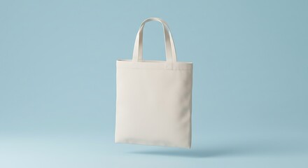 A plain, cream-colored canvas tote bag floats against a light blue background.
