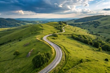 Experience the freedom of the open road with this scenic drive through rolling green hills and dramatic skies
