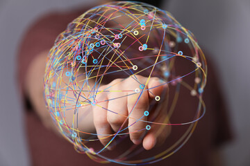 Abstract image of a hand interacting with a colorful global network, representing connection and...