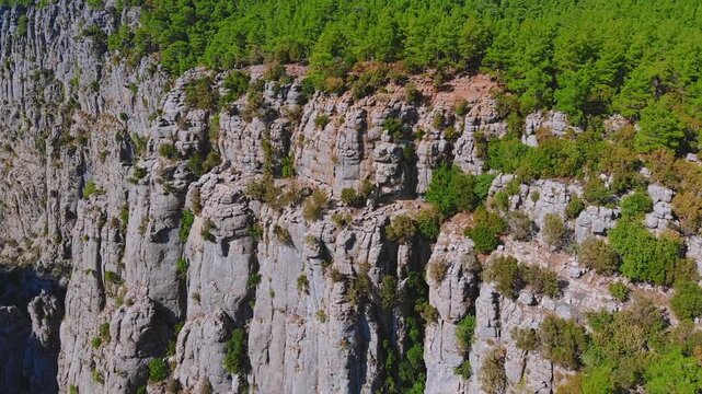 Traveler hiker on rocky cliff edge overlooking vast Tazi Canyon landscape in Manavgat, Antalya, Turkey.
