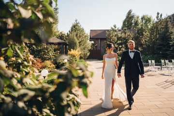 Beautiful and in love bride and groom on a walk in the autumn park