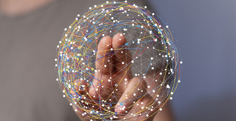 Abstract image of a hand interacting with a digital global network. Represents connection,...