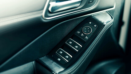 Close-up view of modern car door control panel featuring window and lock buttons, showcasing sleek...