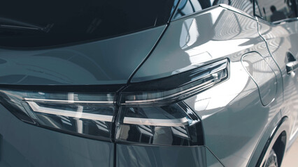 Sleek modern car rear view showcasing stylish taillights and reflective surfaces in a contemporary...