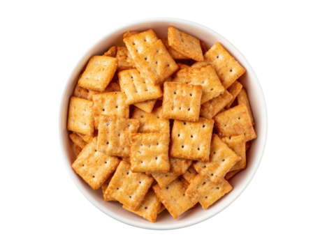Square crackers in a white bowl.  Top down view.  Golden-brown, crispy, bite-sized crackers.  Small,  evenly sized squares with perforations.  Full bowl