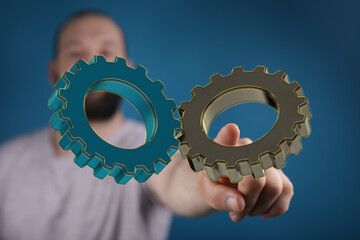 Image of two gears meshing, symbolizing teamwork, collaboration, and synergy in business.