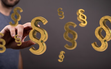 Abstract image of a hand interacting with golden paragraph symbols, representing legal concepts and law.