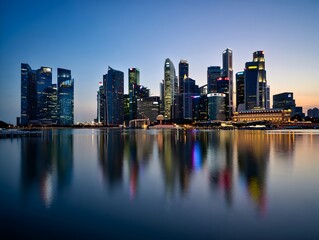 Fototapeta premium Explore singapore skyline at night a stunning cityscape with reflections on water surface