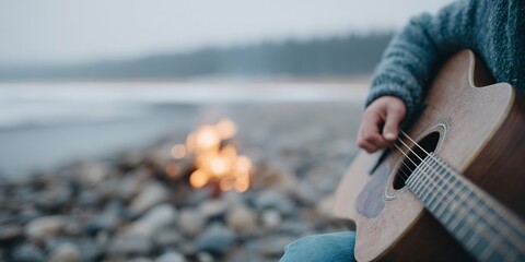 Person is playing a guitar on a beach with a fire in the background