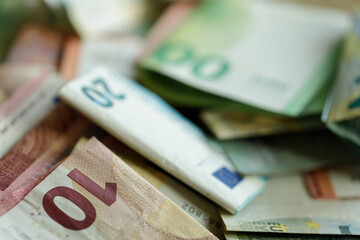 Close-up shot of various Euro banknotes, showing detail and texture.