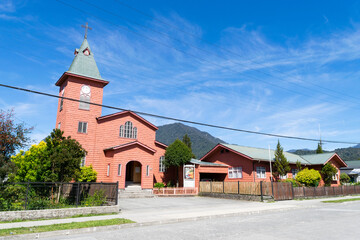 Pink church standing in chile's patagonia region under blue sky
