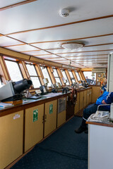 Captain sitting in the command bridge of a ferry in chile patagonia
