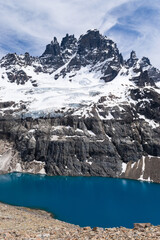 Turquoise lake reflecting snowy mountain peaks in patagonia, chile