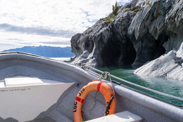 Boat approaching marble caves of patagonia in chile