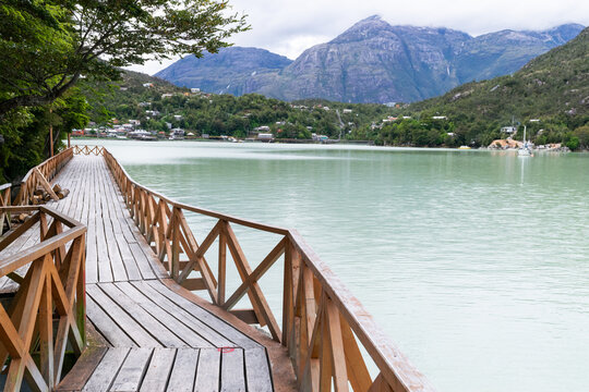 Wooden pier stretching into the serene waters of patagonia, chile