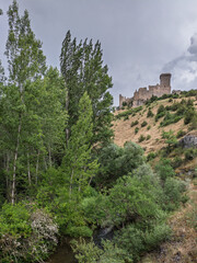 Ucero River flows by Ucero Castle in Spain's forest