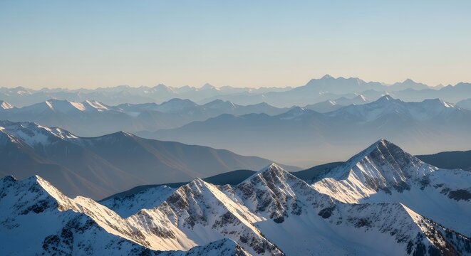 Aerial view of snow capped mountains under a clear blue sky day - Powered by Adobe