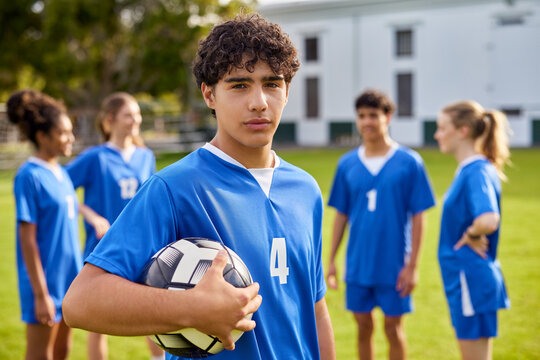Portrait of focused player guy at soccer field