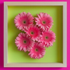 Pink gerbera daisies in a light green frame.