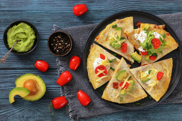quesadilla with cheese, bacon, avocado on a plate