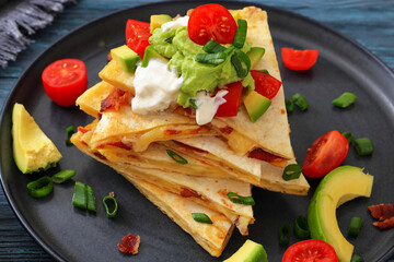 quesadilla with cheese, bacon, avocado on a plate