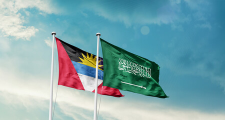 Antigua and Barbuda and Saudi Arabia friendship flags are waving in the sky. Two country flag for...