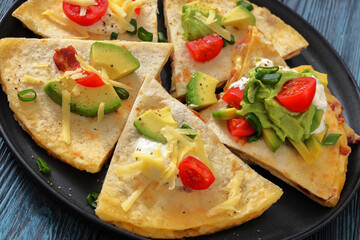 quesadilla with cheese, bacon, avocado on a plate