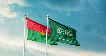 Burkina Faso and Saudi Arabia friendship flags are waving in the sky. Two country flag for agreement or deal. Burkina Faso KSA national flag for commitment.
