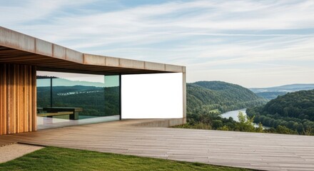 Obraz premium Modern building with floortoceiling windows overlooking a scenic valley with a river merging indoor and outdoor space