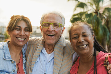 Happy diverse eldelry people smiling on camera in the city - Multiracial senior friendship and...
