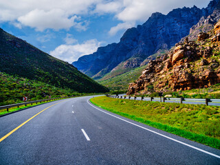 Naklejka premium N1 Highway winding through a valley with Du Toitskloof Mountains backdrop, Western Cape, South Africa