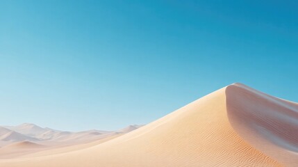Golden sand dune rises against clear blue sky, showcasing serene