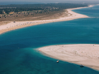 Scenic view of Troia beach and coastline in Portugal on a sunny day with clear waters and sandy shores