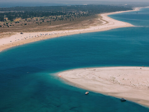 Scenic view of Troia beach and coastline in Portugal on a sunny day with clear waters and sandy shores