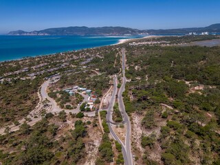 Expansive view of Troia Portugal showcasing winding roads and sandy beaches under clear blue skies