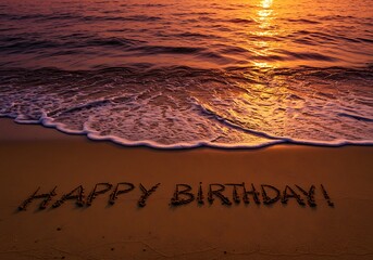 Happy Birthday message written in the sand at sunset on the beach