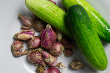Fresh Cucumbers and Shallots on a White Plate