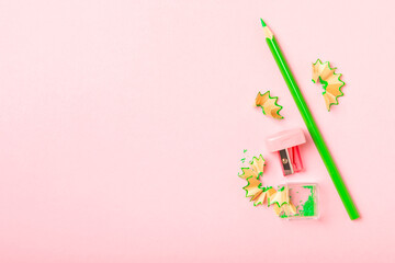 Pencil sharpener on bright colored background. Pencil and pencil shavings. Stationery. School...