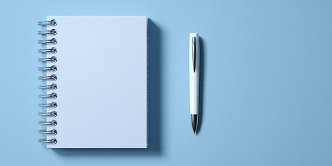 Spiral notebook and pen on blue background stationery flat lay office desk supplies

