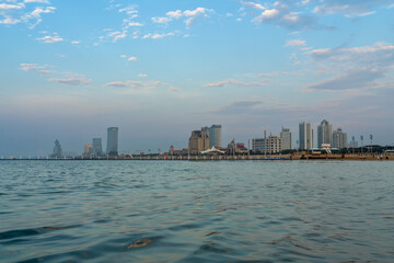 The coast of Bohai Bay in the Yellow Sea and Yantai Golden Beach Coastal Park on a summer evening...