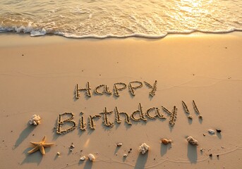 Happy Birthday message written in the sand on a beach at sunrise