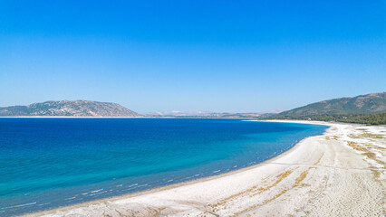 The tranquil beauty of Salda Lake - Turkey with its crystal clear turquoise waters and stunning surrounding landscapes is a mesmerizing sight to behold.