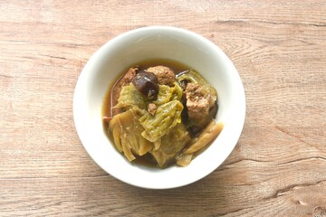 boiled pickled cabbage and bitter cucumber with tofu topping black mushroom in Chinese herb soup on...