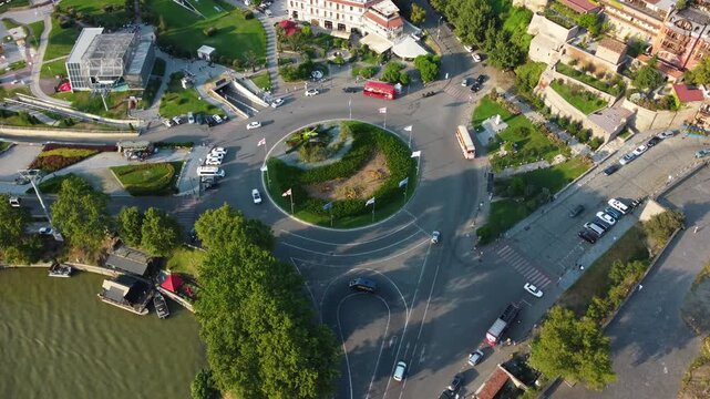 Roundabout traffic in Georgia, Rike Park. Country flag. Drone view