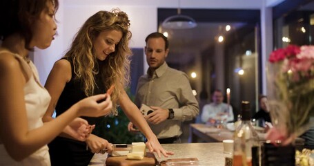 Friends Preparing Snacks and Drinks, Chatting and Laughing in a Modern Kitchen During a Dinner Party - Powered by Adobe